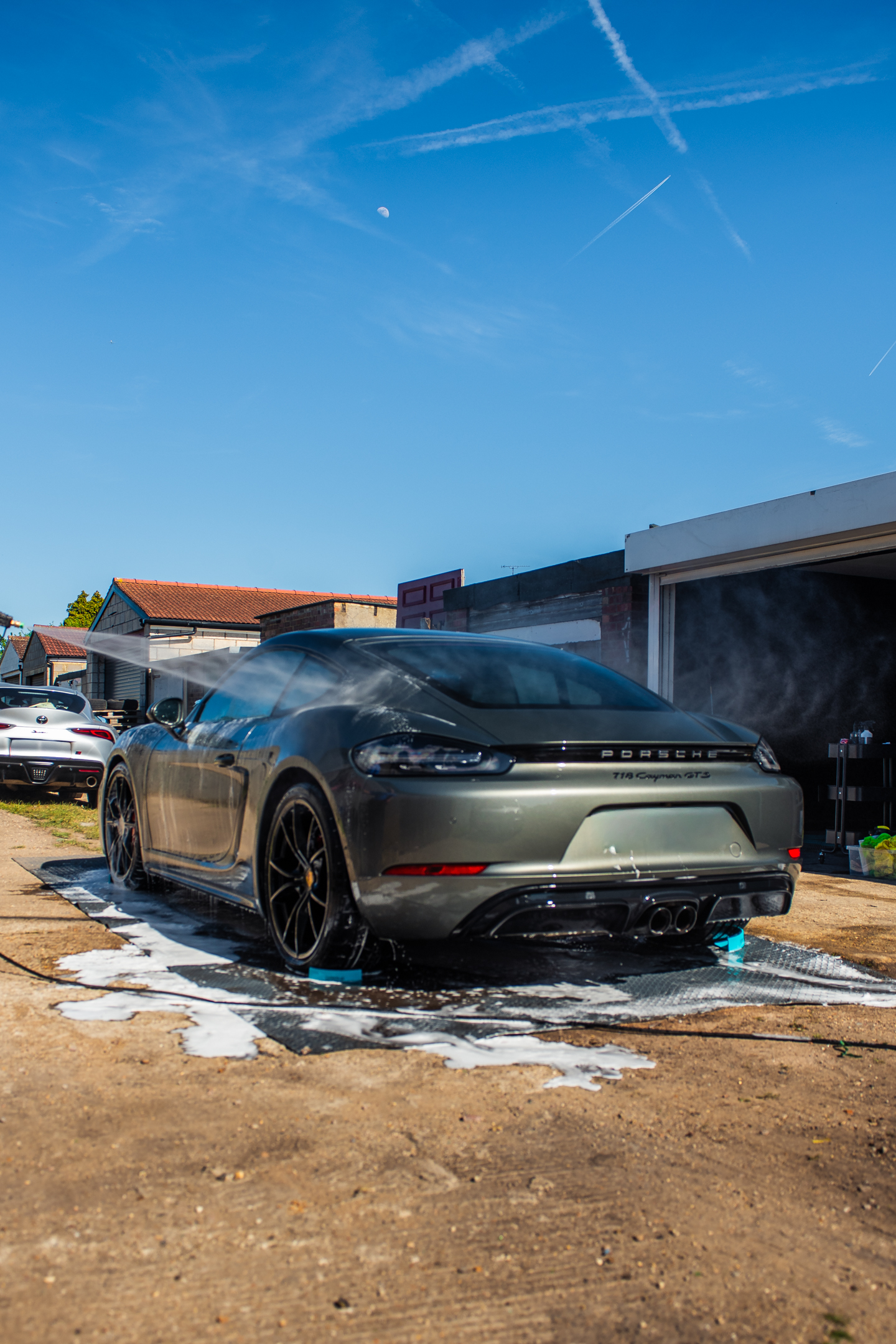 Porsche being pressure rinsed during an S21 wash